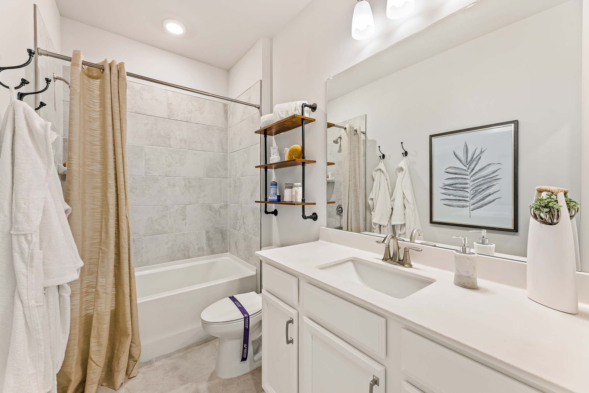 A bathroom with a tub sink and toilet.