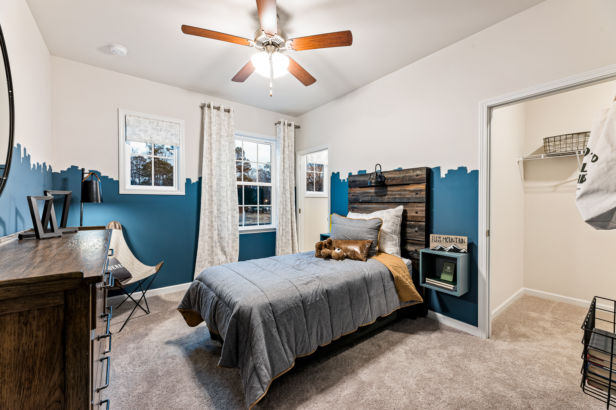 A bedroom with a bed and a fan.