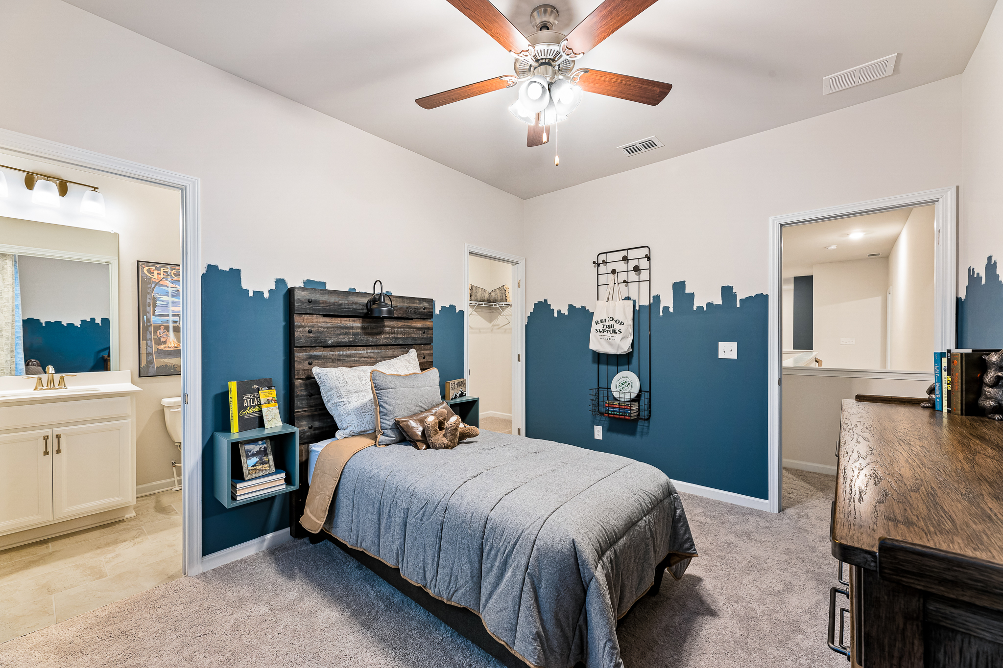 A bedroom with a bed and a fan.