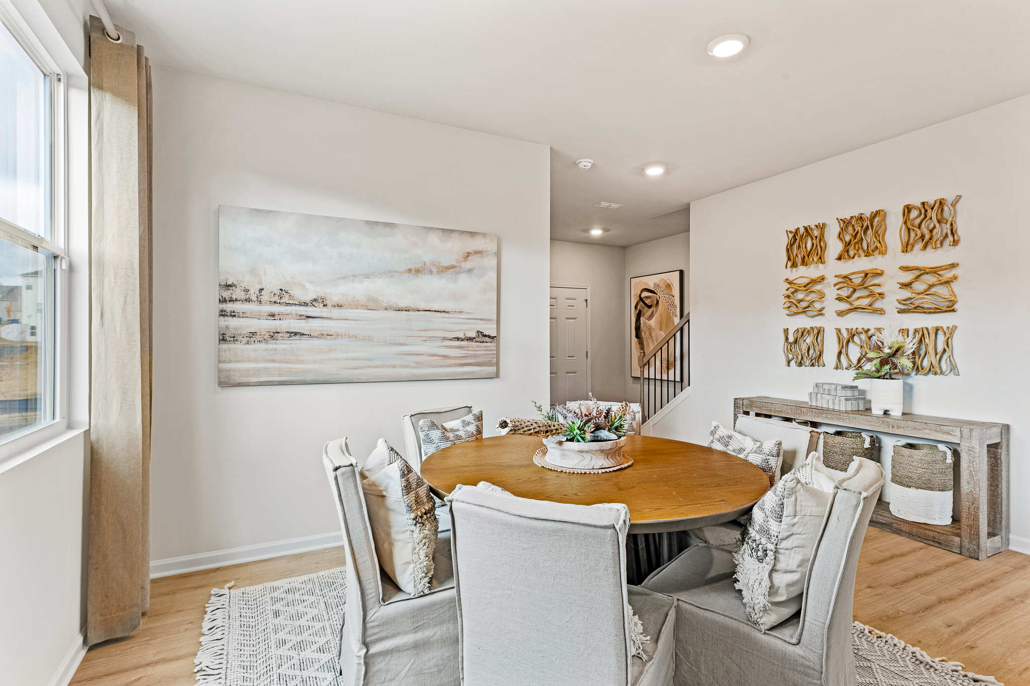 A living room with a table and chairs.