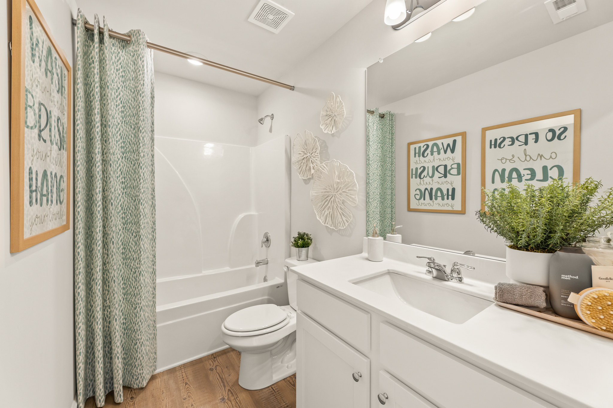 A bathroom with a tub sink and toilet.