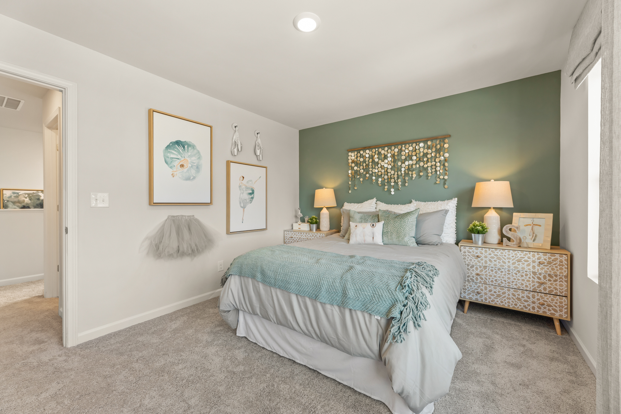 A bedroom with a bed and lamps.