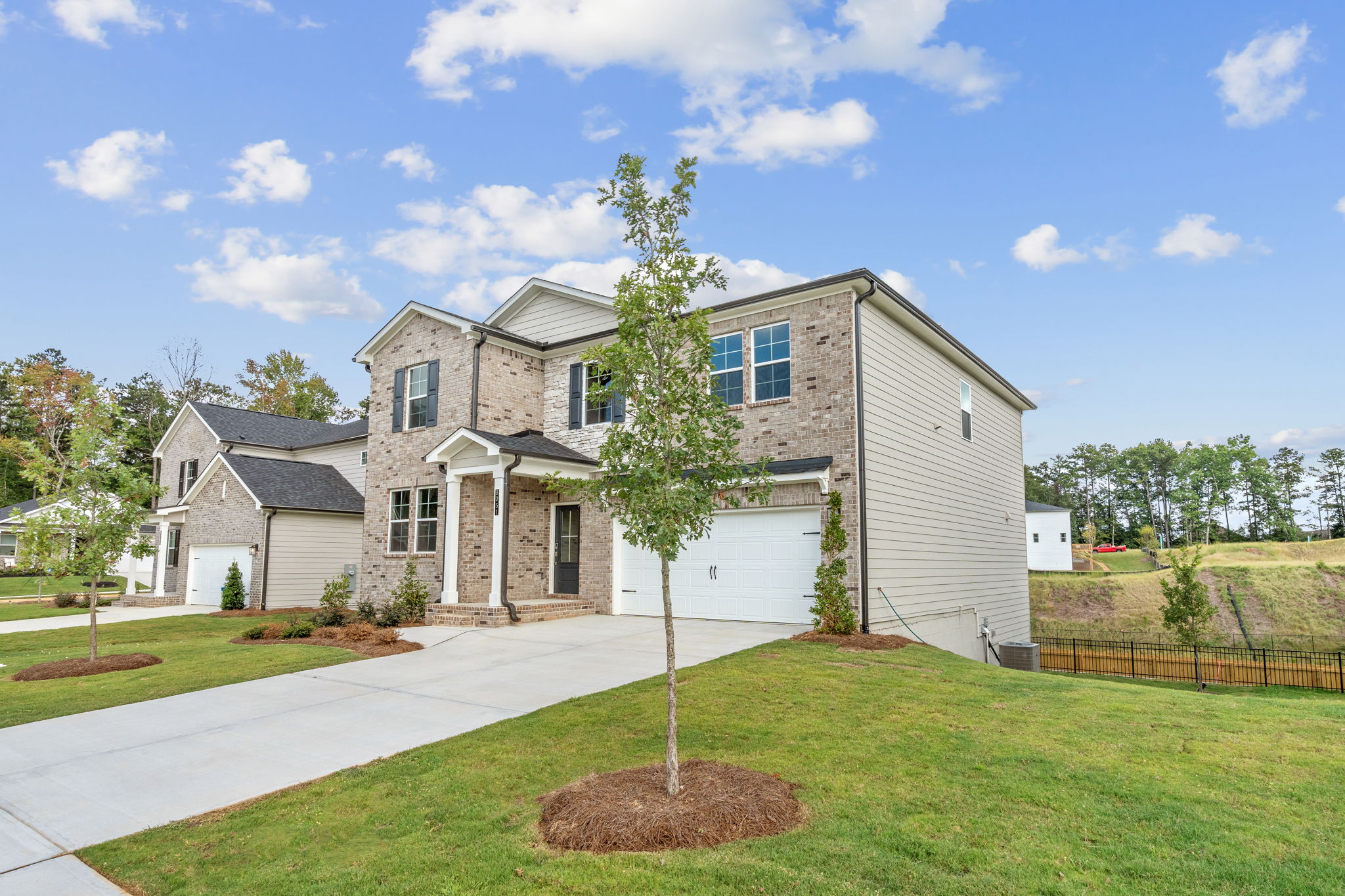 A house with a tree in the front yard.