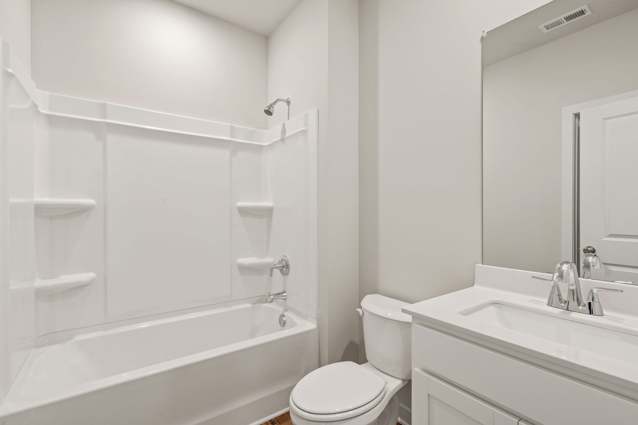 A bathroom with a tub toilet and sink.