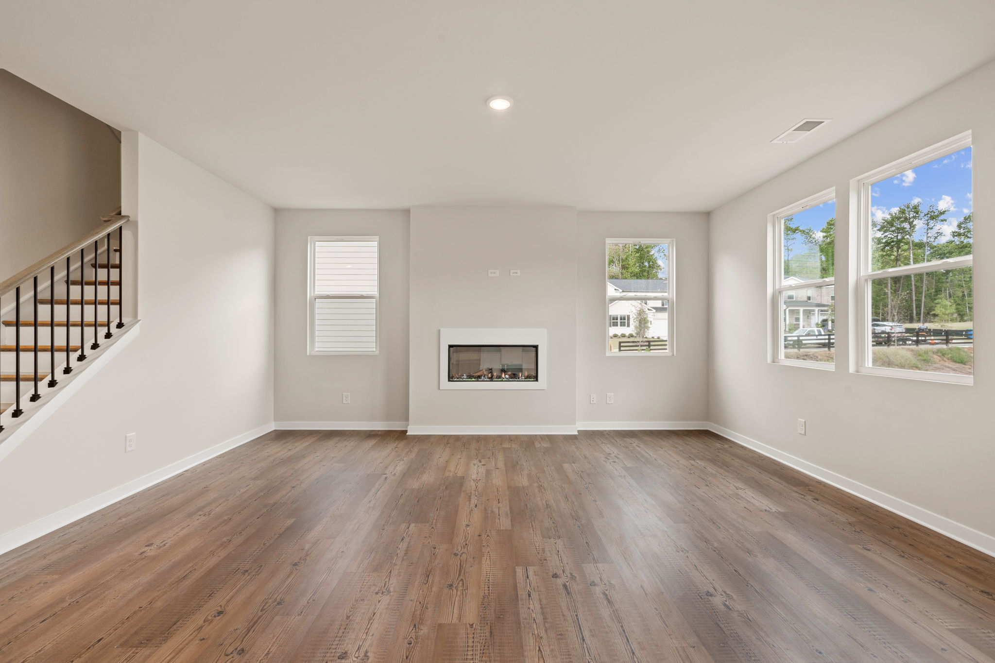A room with a wood floor and windows.