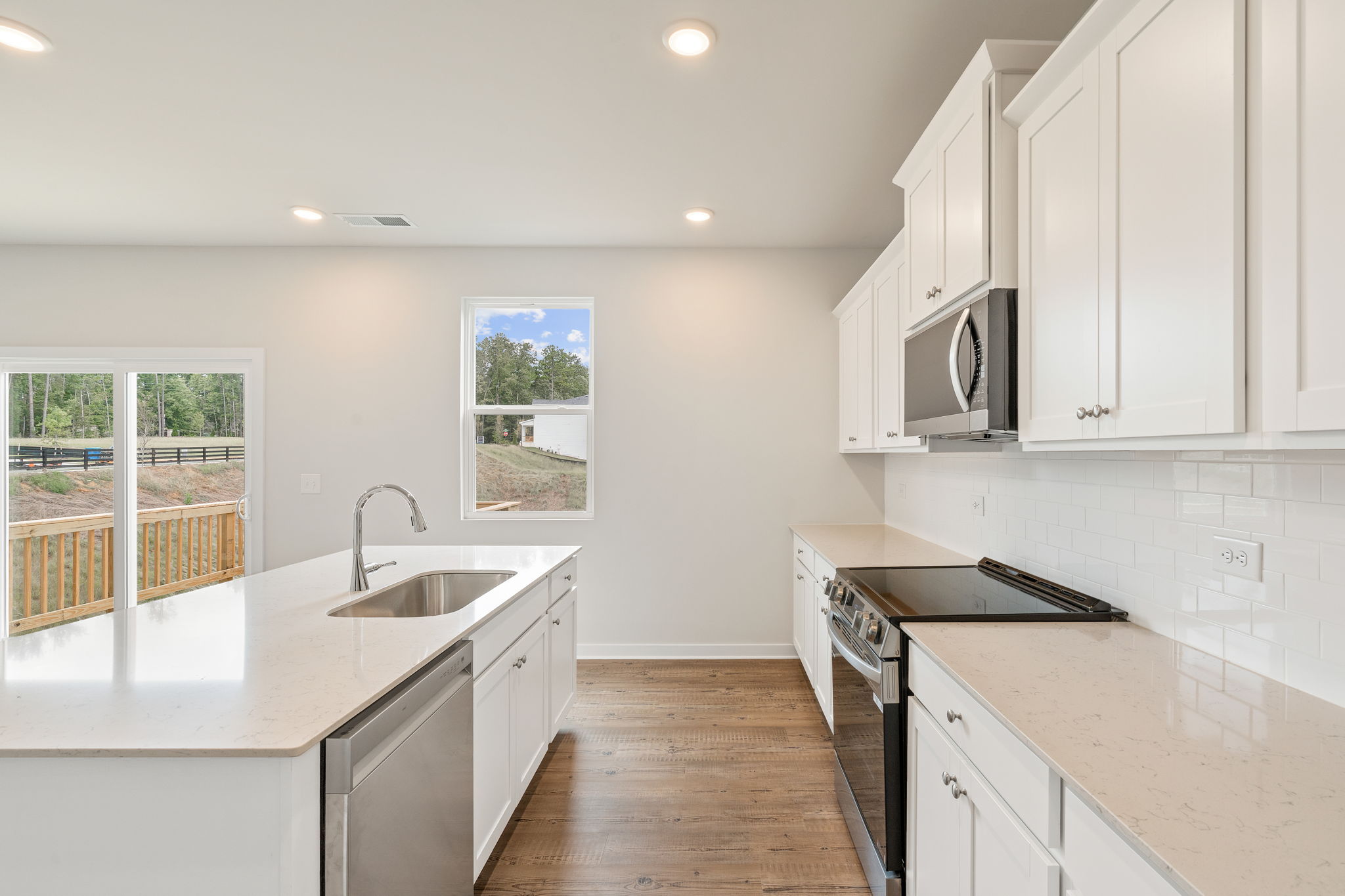 A kitchen with white cabinets.