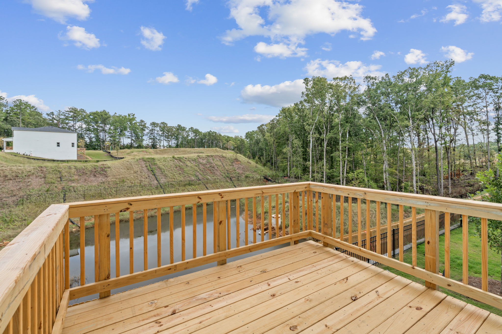 A wooden deck with trees in the background.