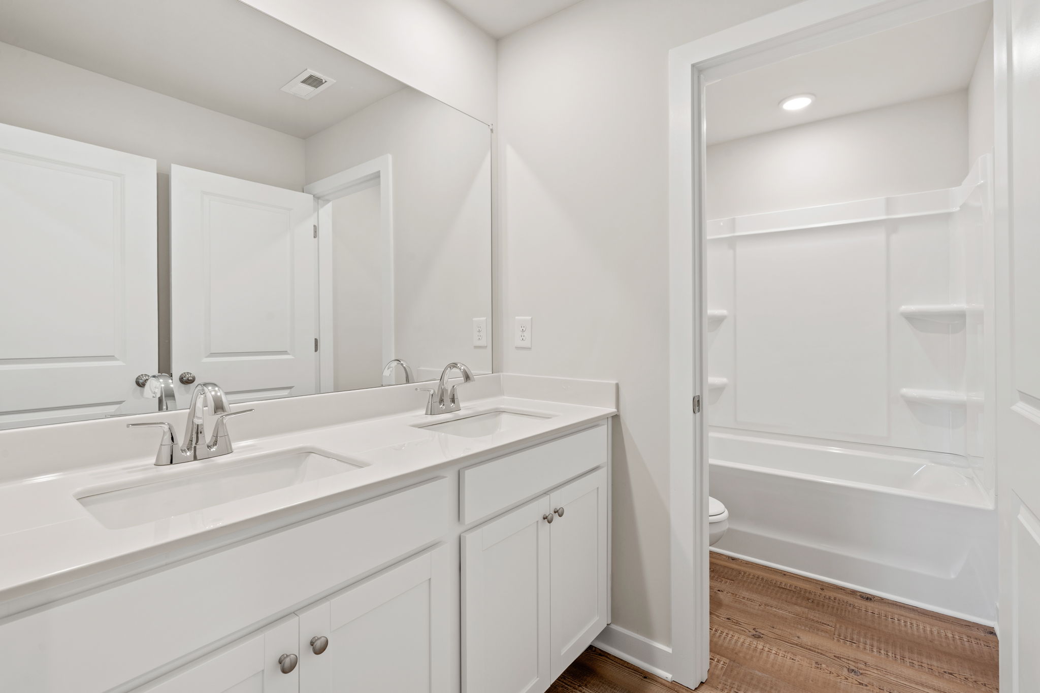 A bathroom with a tub sink and a shower.