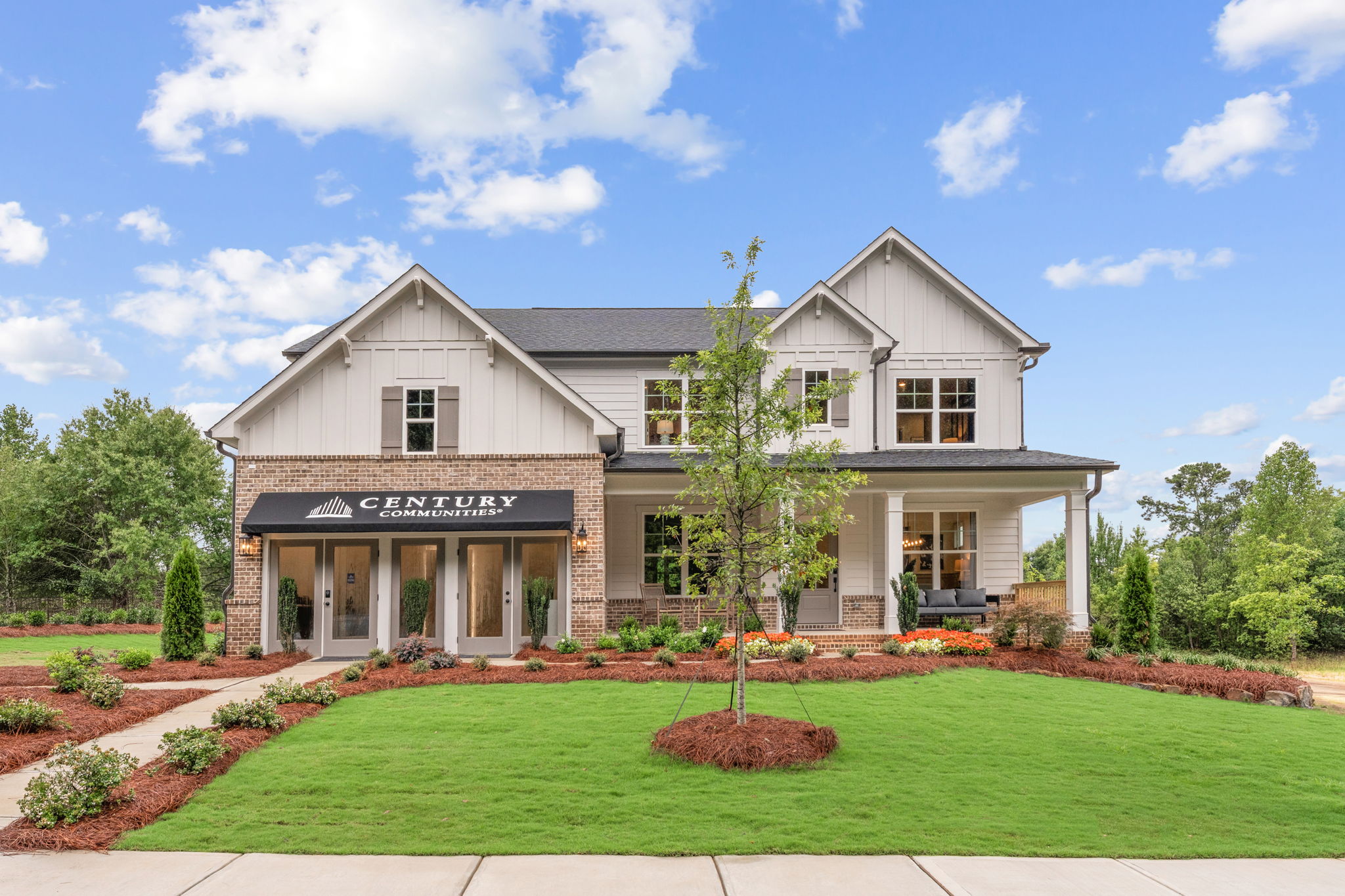 A building with a lawn and trees.