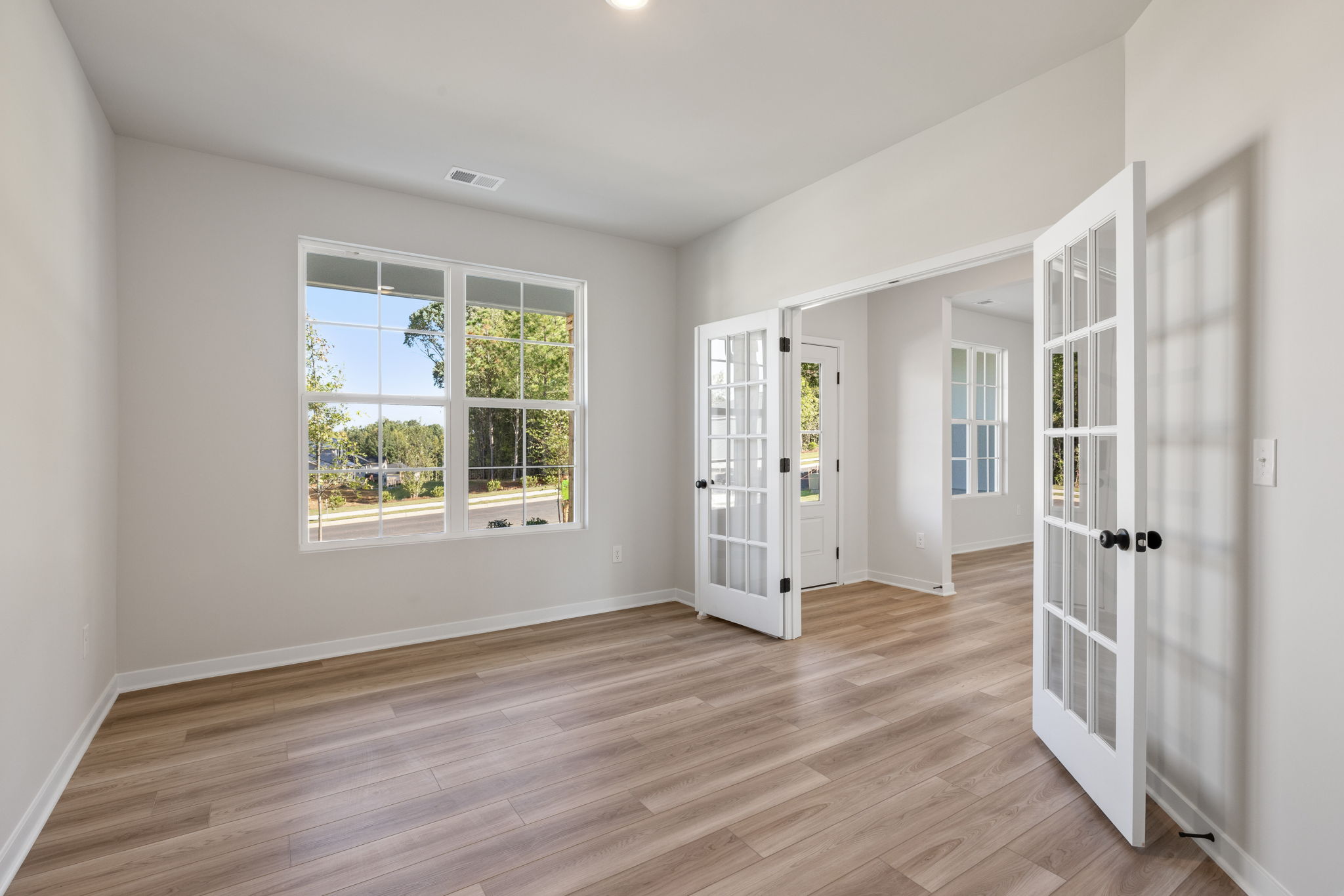 A room with white walls and windows.