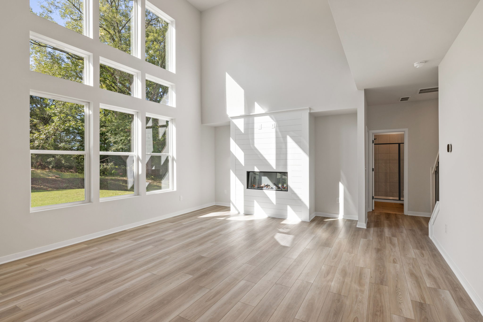 A room with a wood floor and white walls.