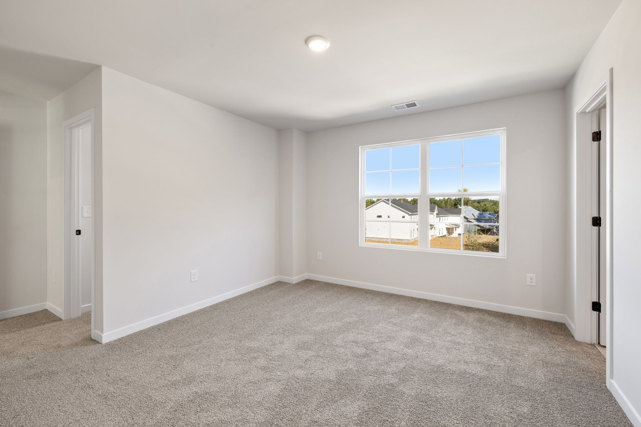 A room with a window and a door.