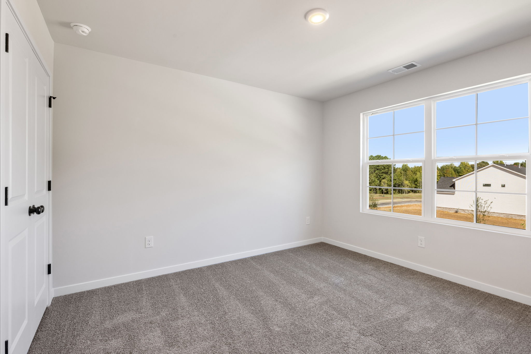 A room with a window and a door.