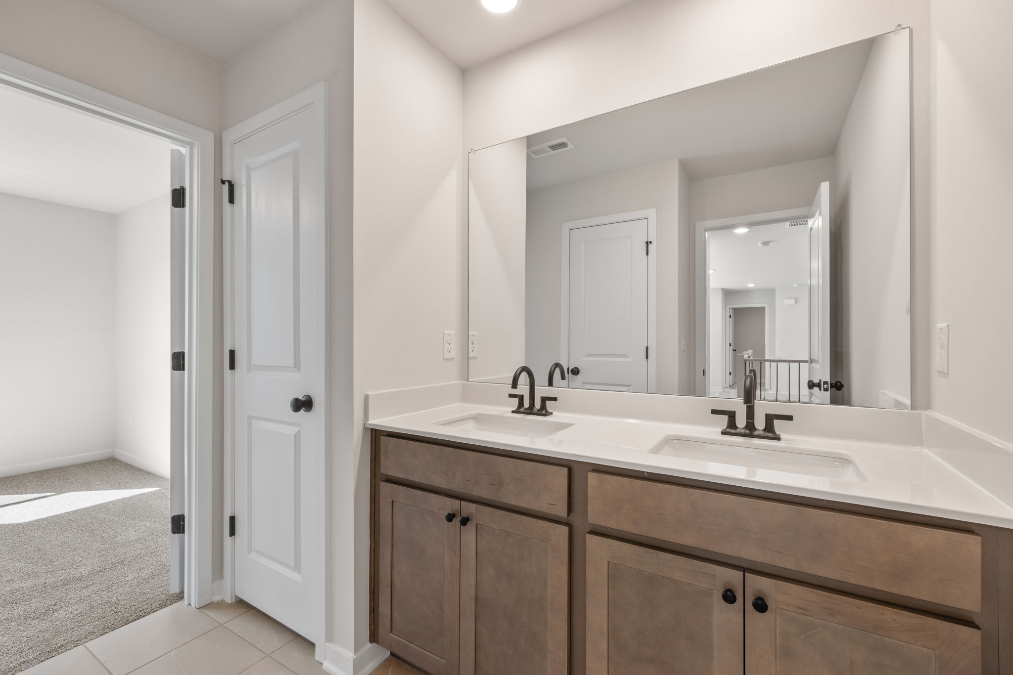 A bathroom with a large mirror.
