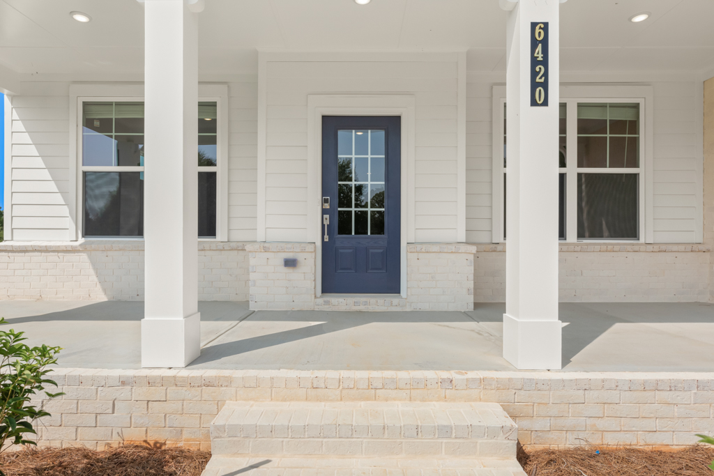 A white building with a blue door.