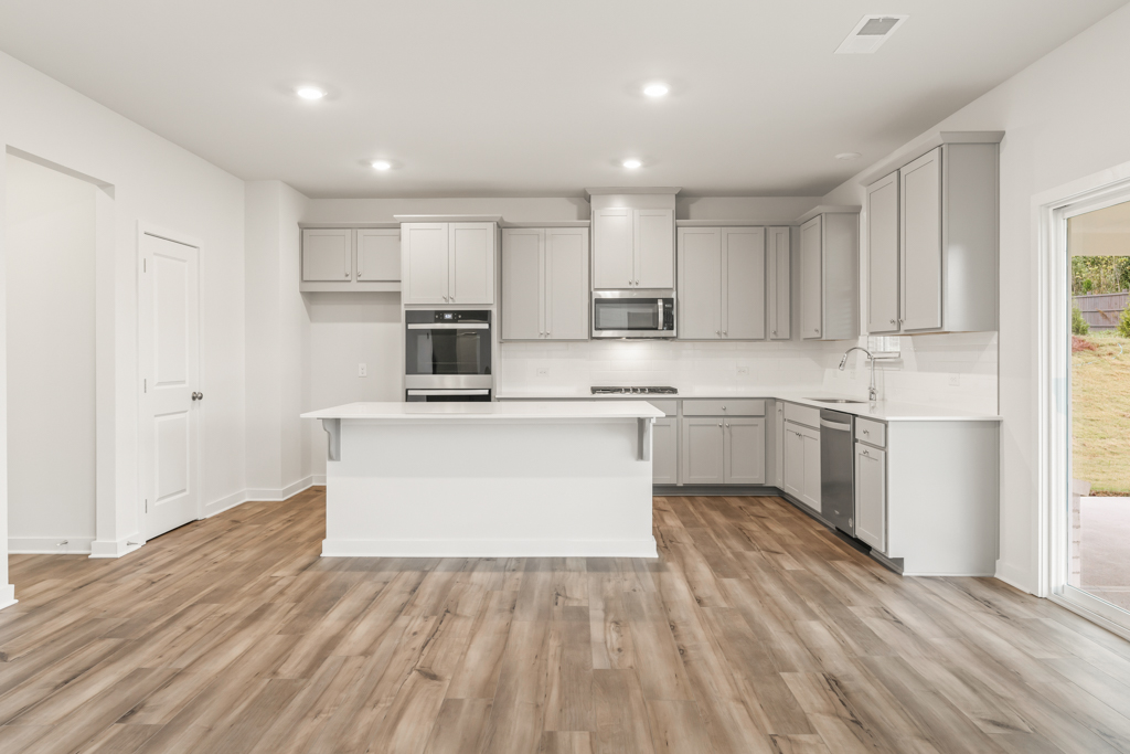 A kitchen with white cabinets.