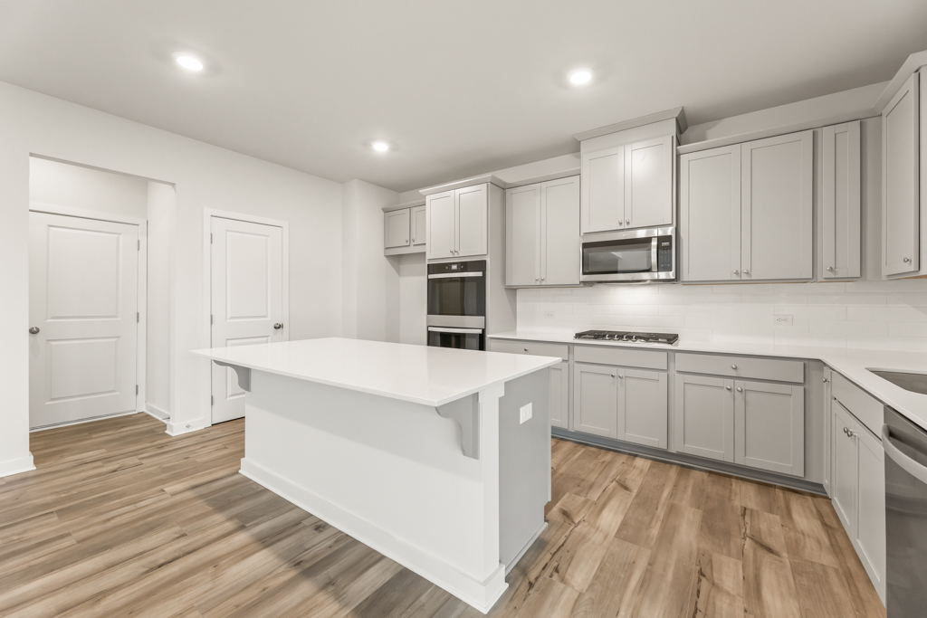 A kitchen with white cabinets.