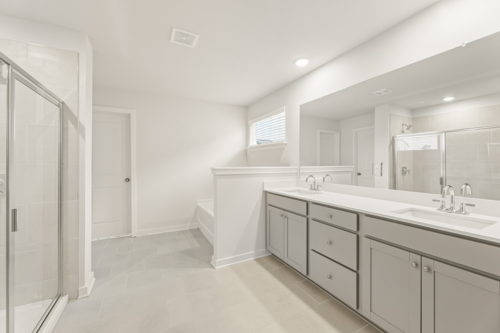 A bathroom with a large mirror.