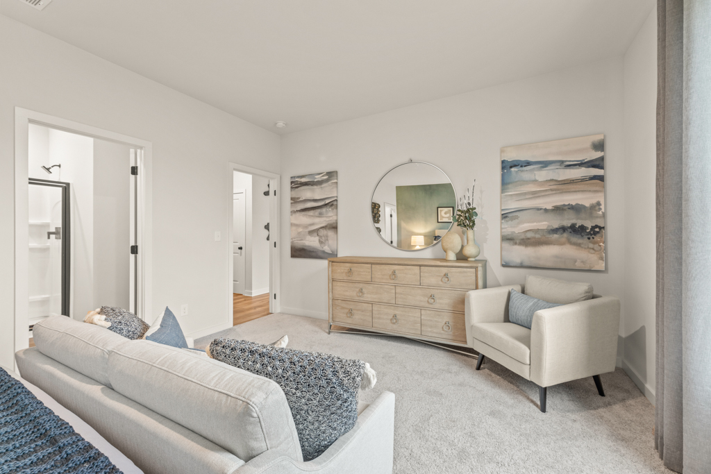 A living room with a couch and a mirror.