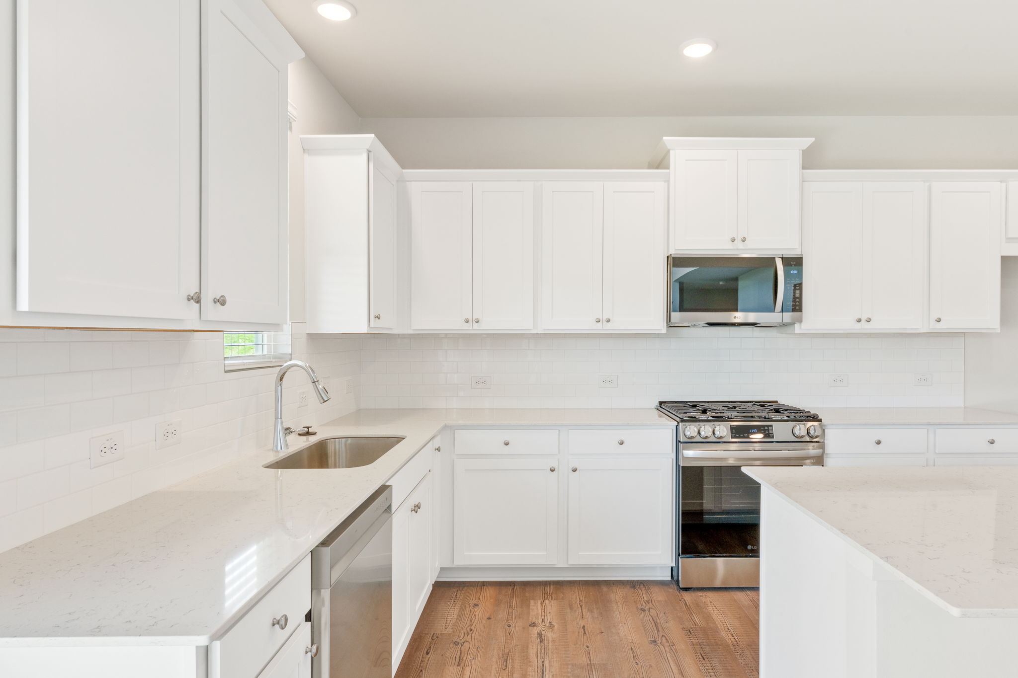 A kitchen with white cabinets.
