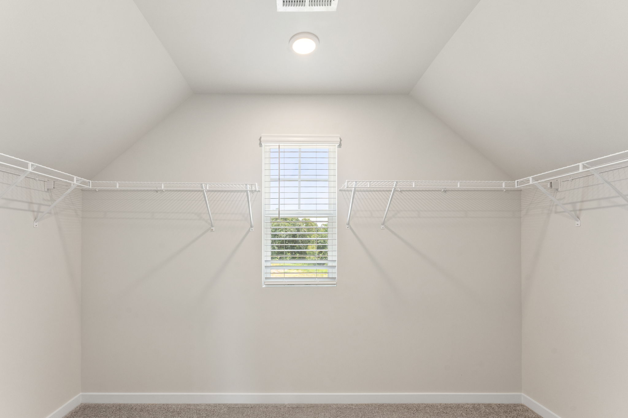 A white room with a window.