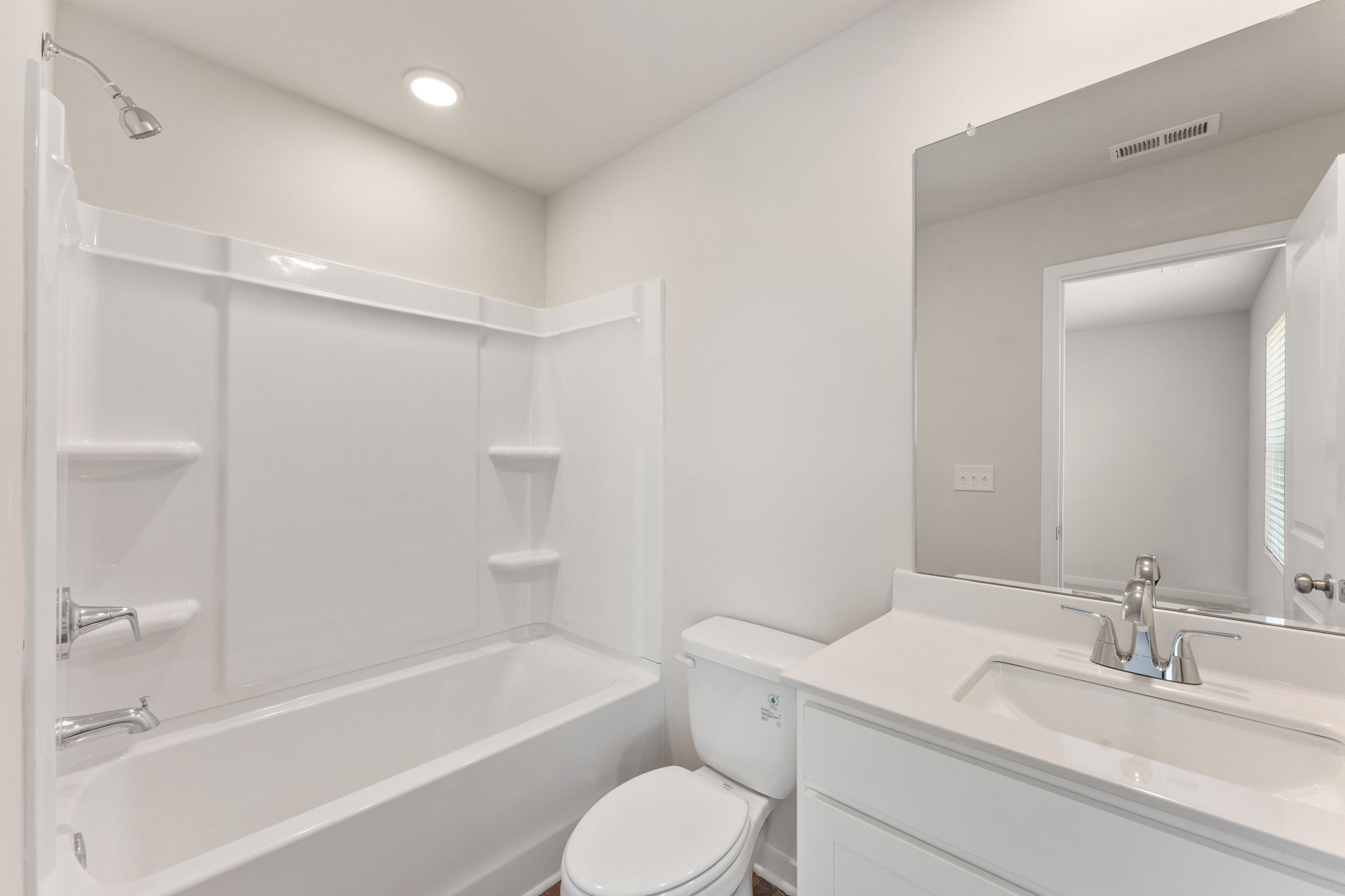 A bathroom with a tub toilet and sink.