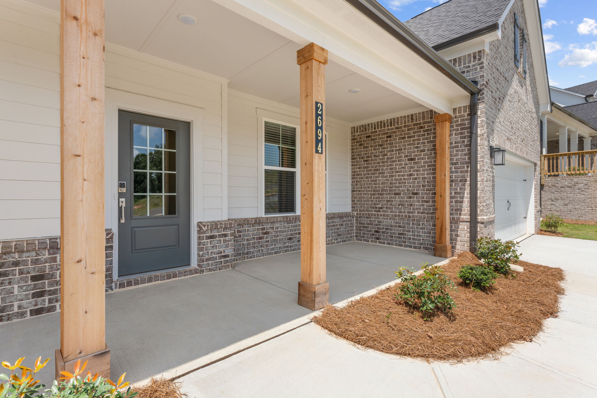 A house with a brick driveway.