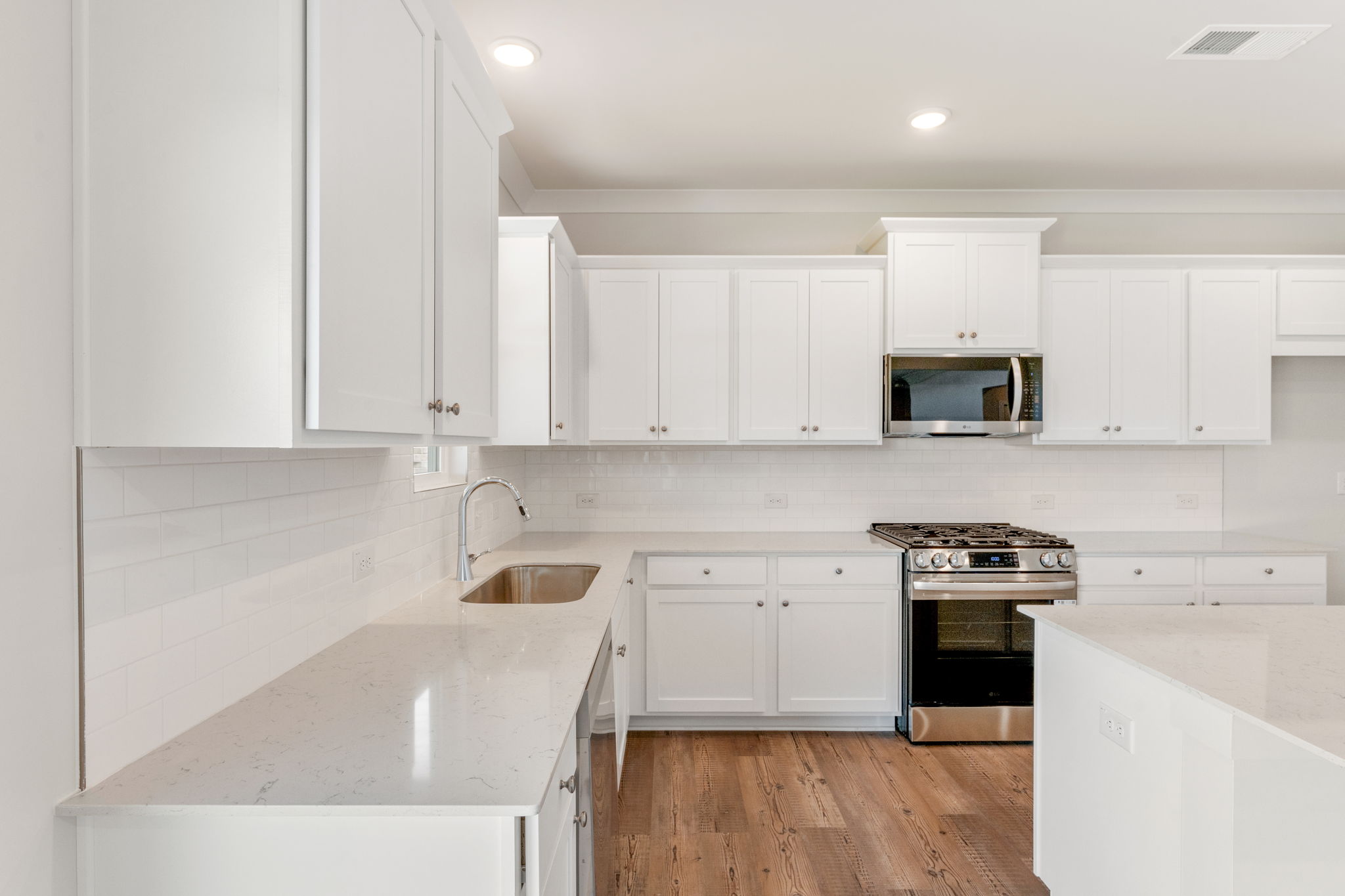 A kitchen with white cabinets.