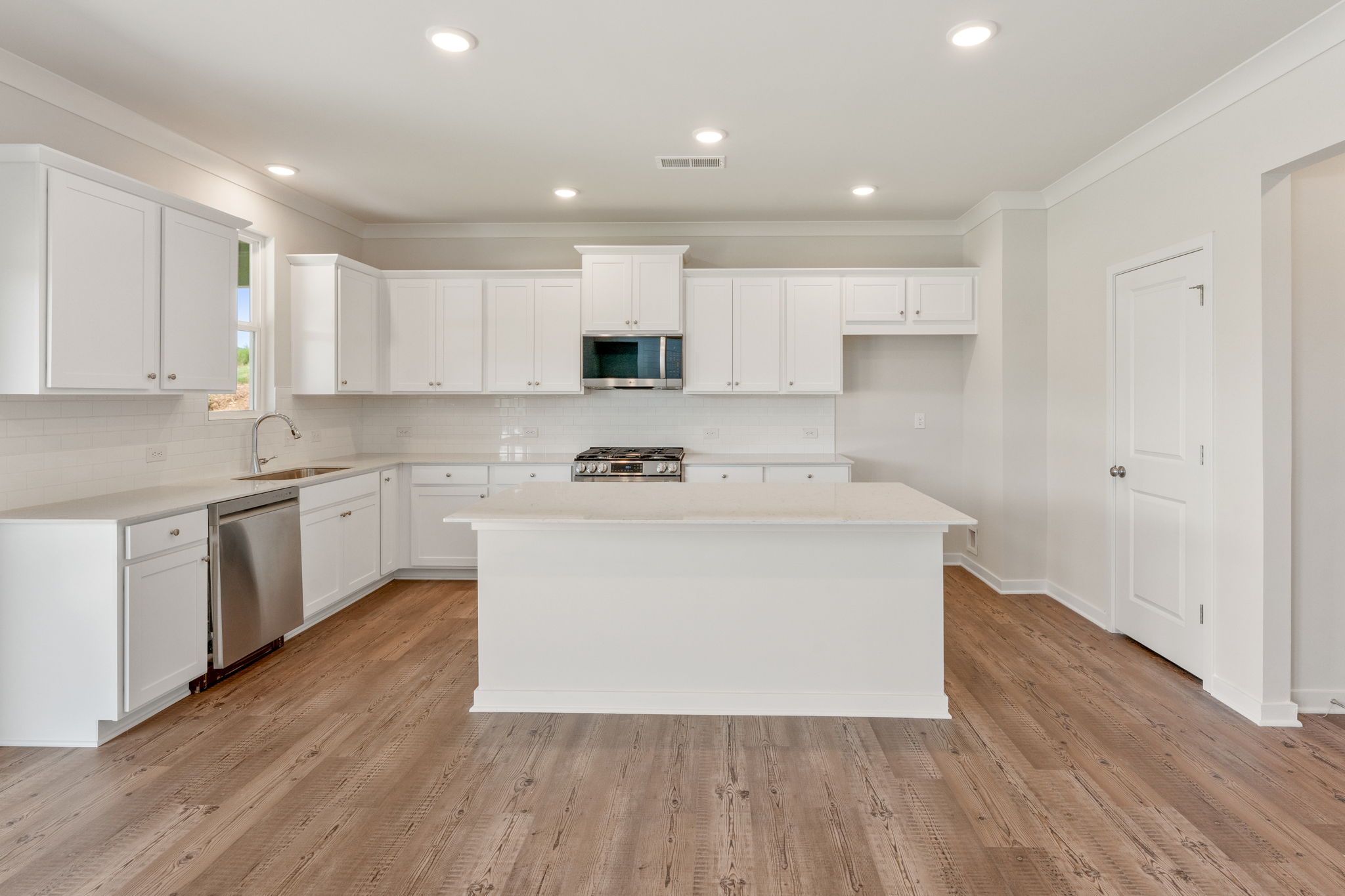 A kitchen with white cabinets.