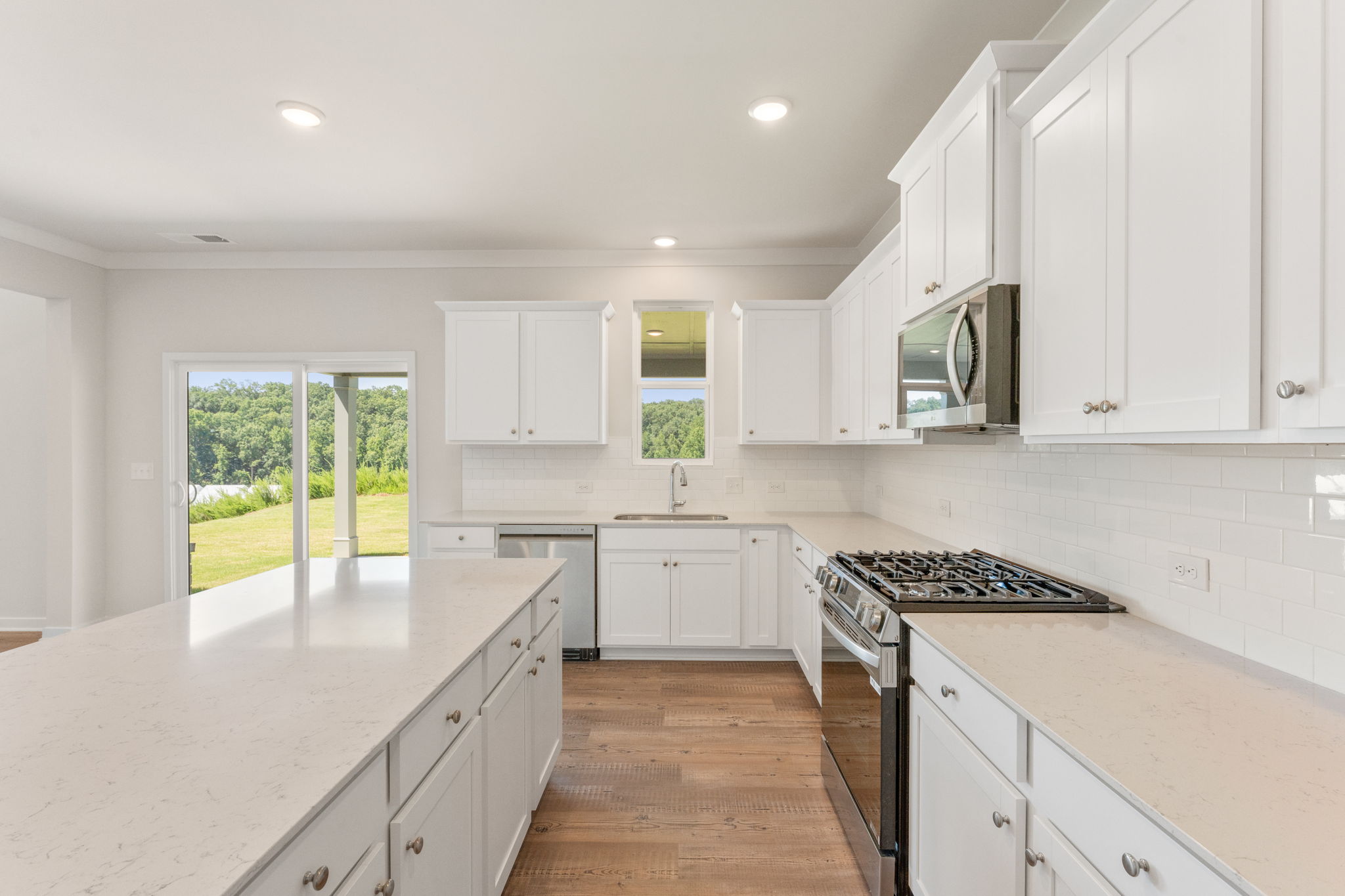 A kitchen with white cabinets.