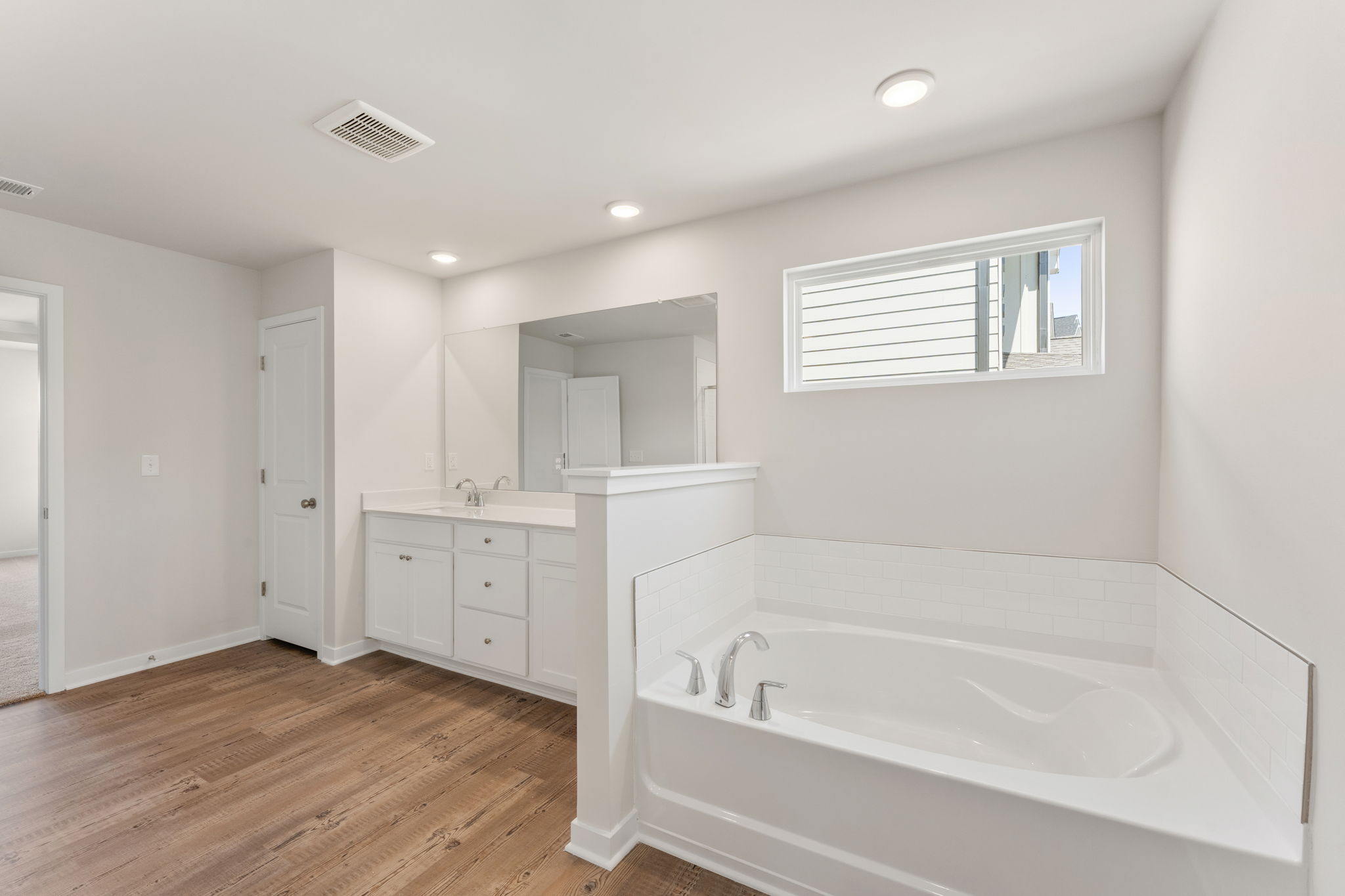A bathroom with a tub and sink.