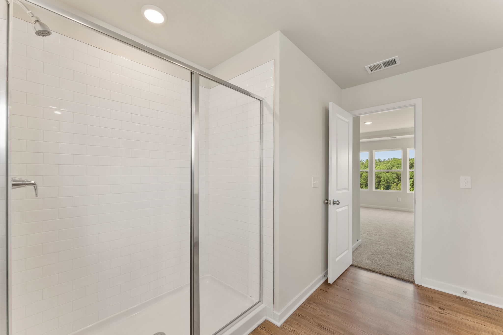 A room with a glass shower.