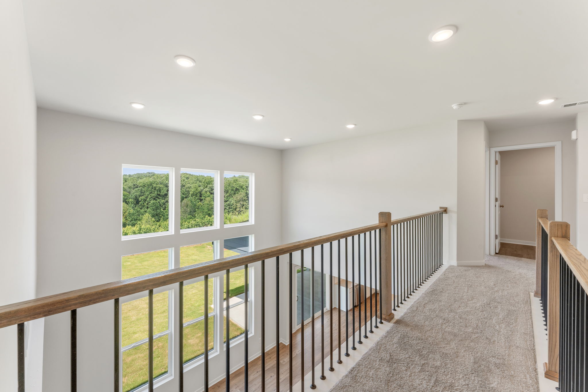 A room with a railing and windows.