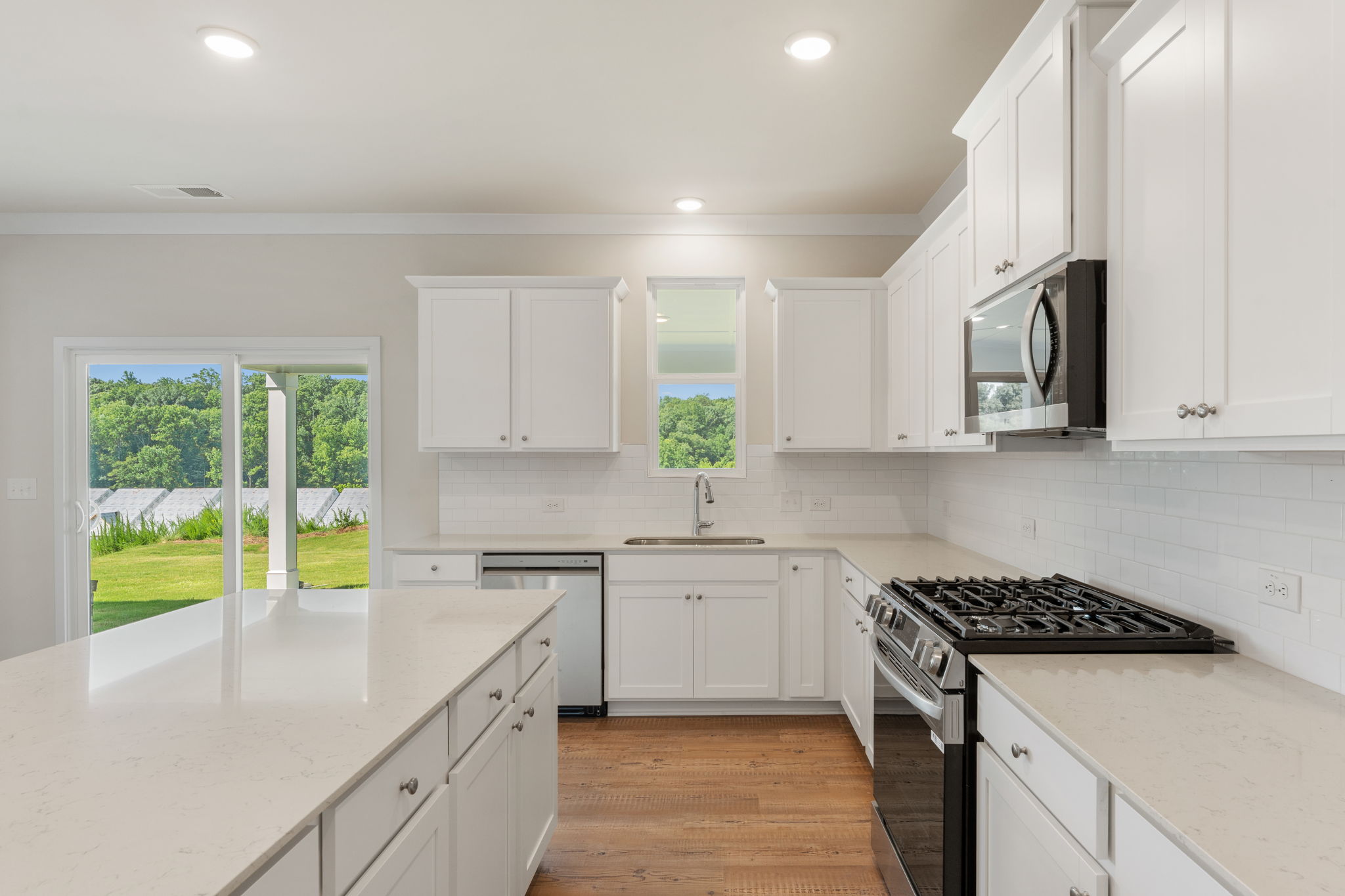 A kitchen with white cabinets.