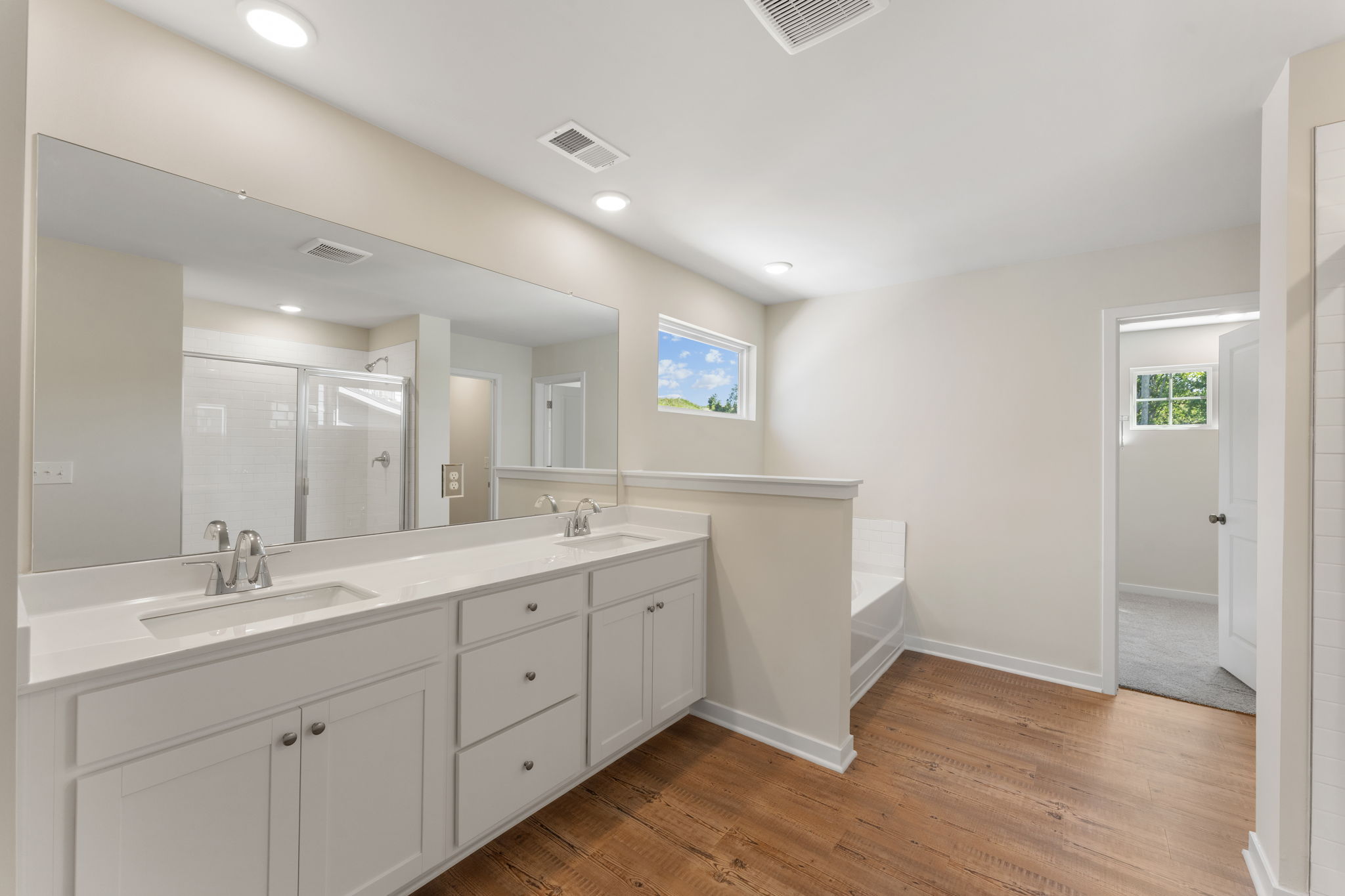 A bathroom with white cabinets.