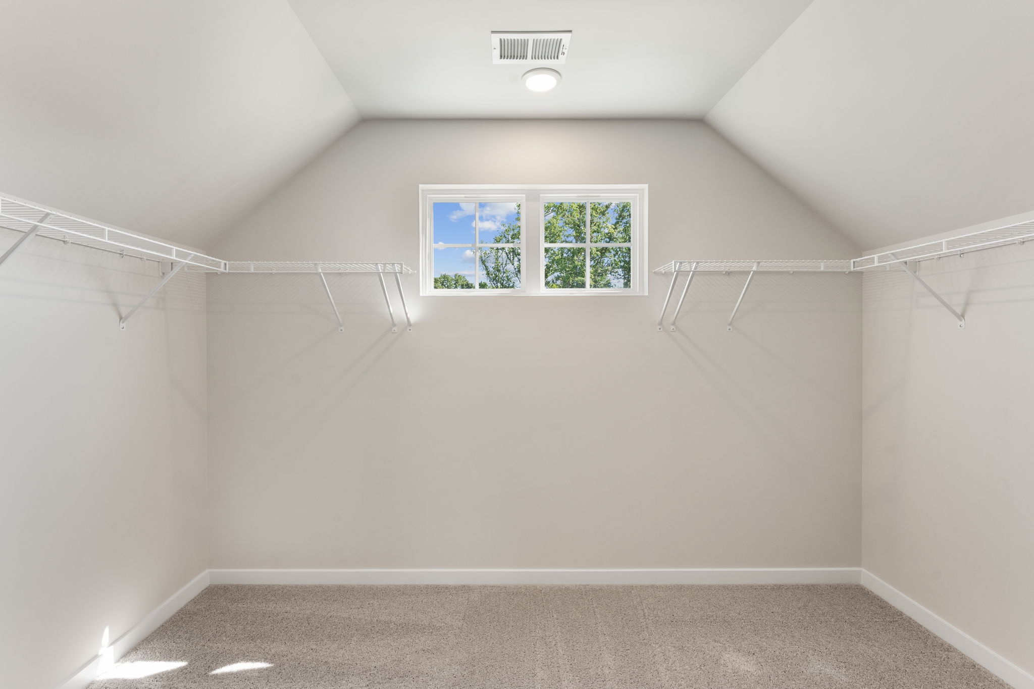 A white room with a window.