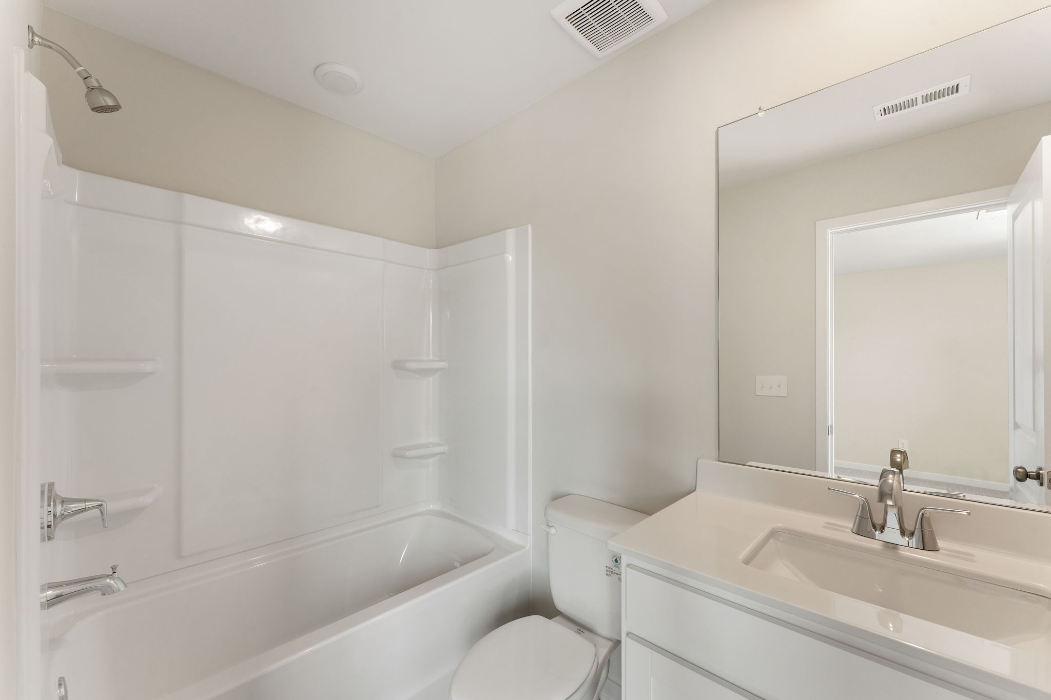 A bathroom with a tub toilet and sink.