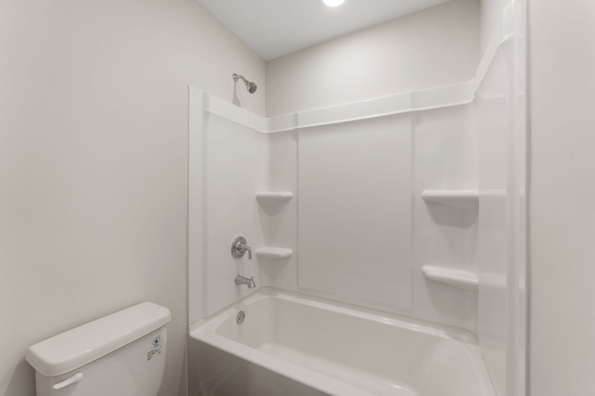 A bathroom with a tub toilet and sink.