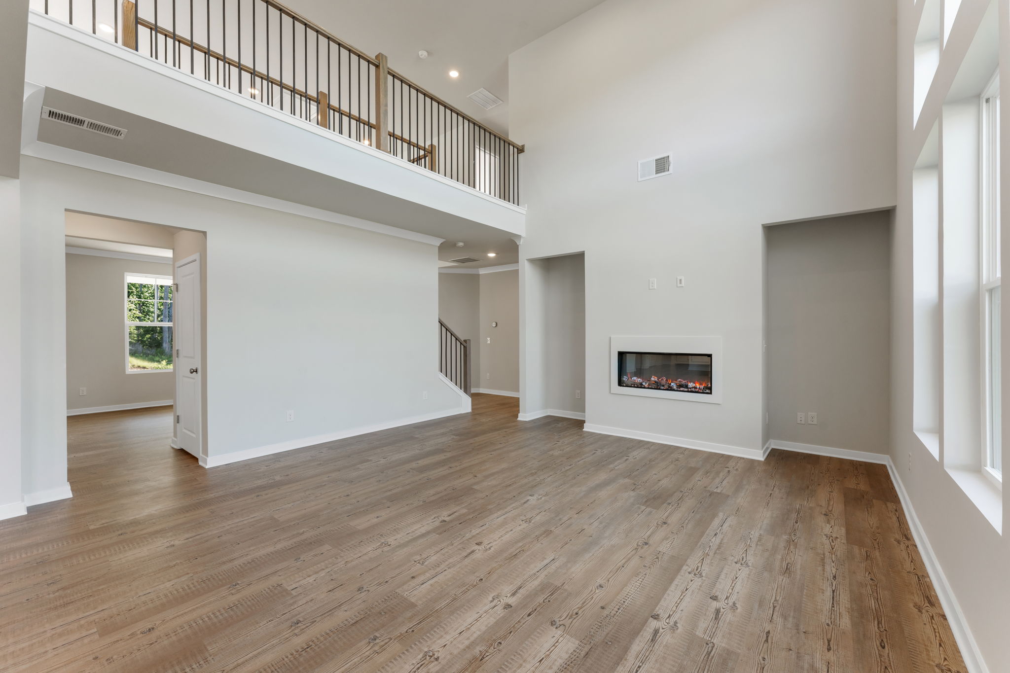 A room with a wood floor and a fireplace.