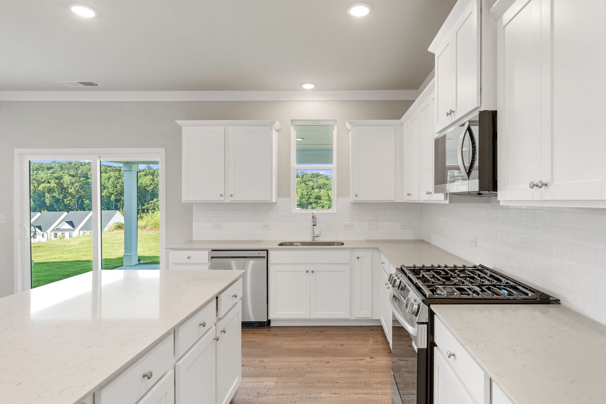 A kitchen with white cabinets.