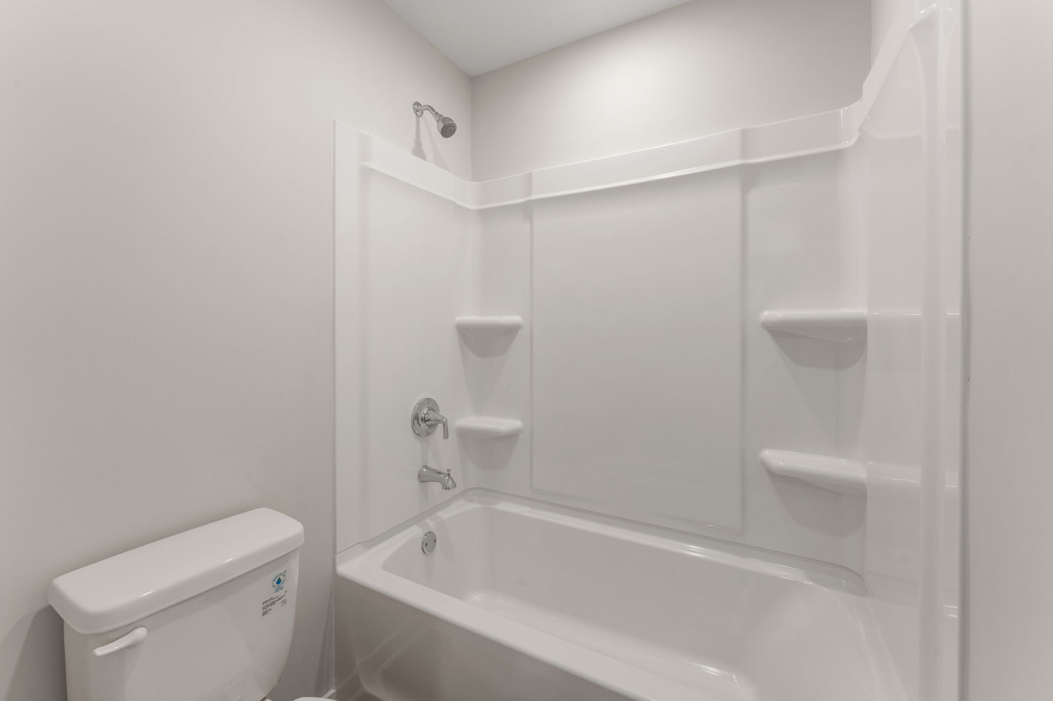 A bathroom with a tub toilet and sink.
