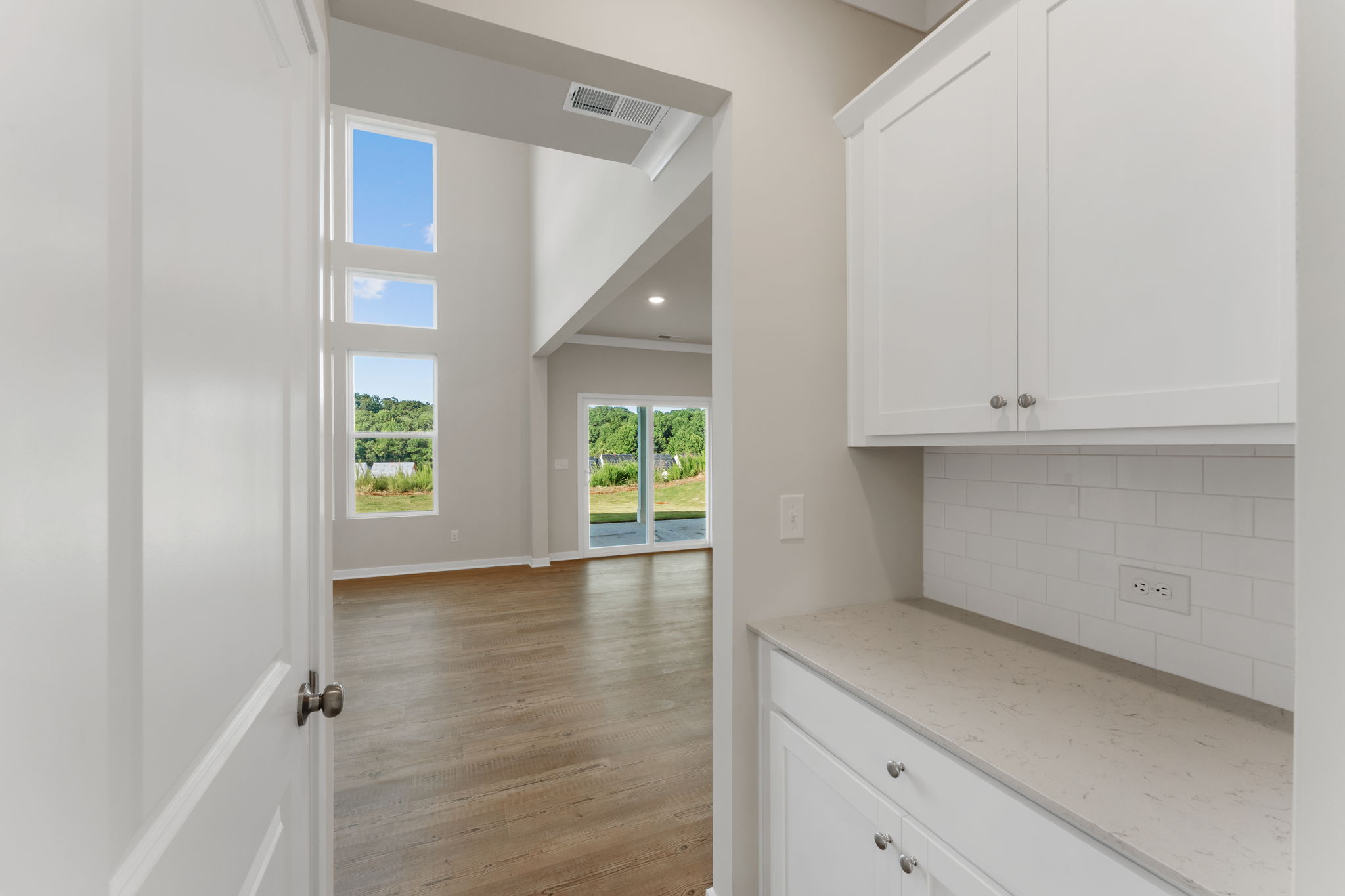 A kitchen with white cabinets.