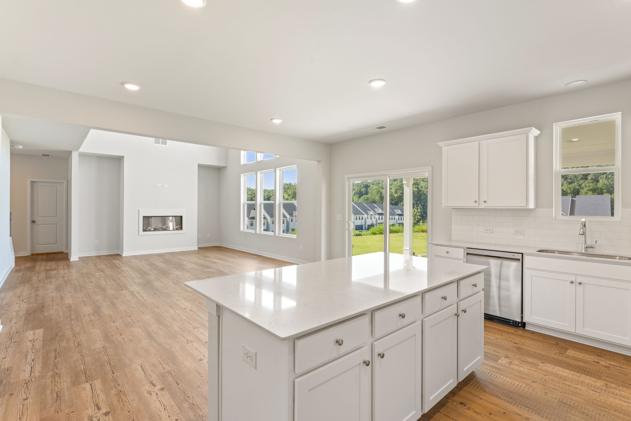 A kitchen with white cabinets.