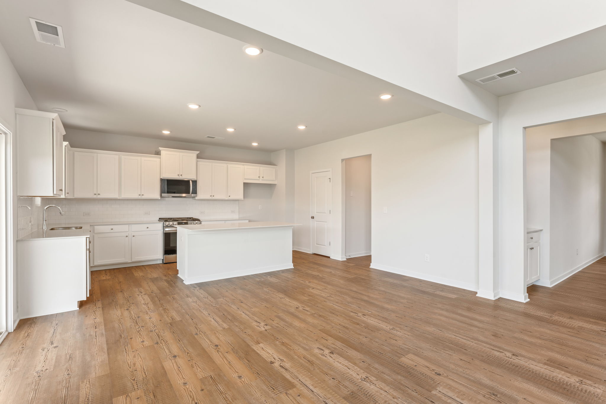 A kitchen with white cabinets.