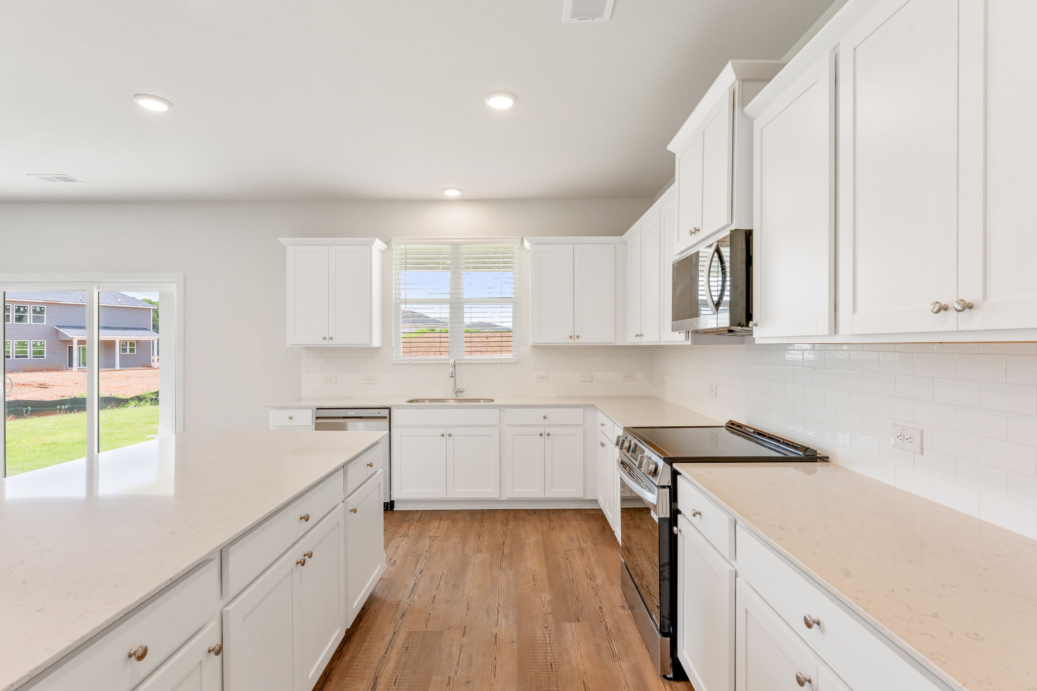 A kitchen with white cabinets.