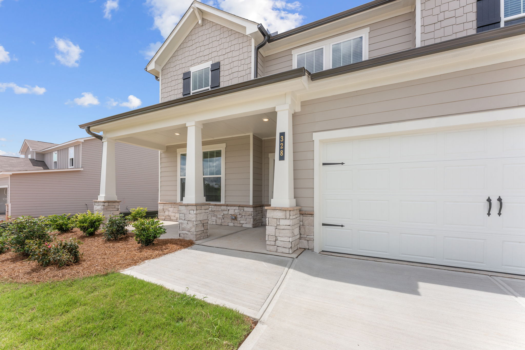 A white house with a garage.