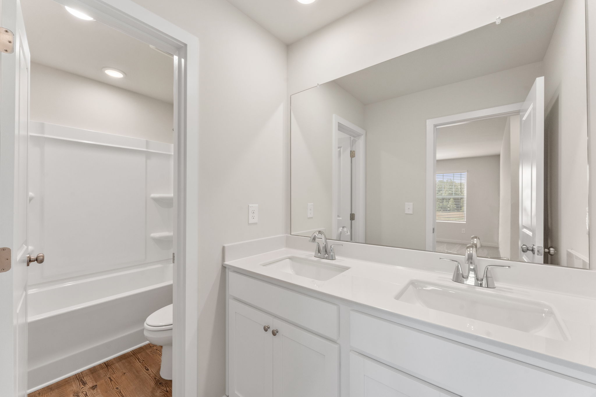 A bathroom with a tub sink and toilet.
