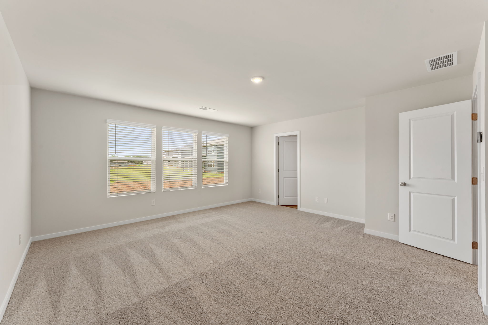 A room with white walls and a window.