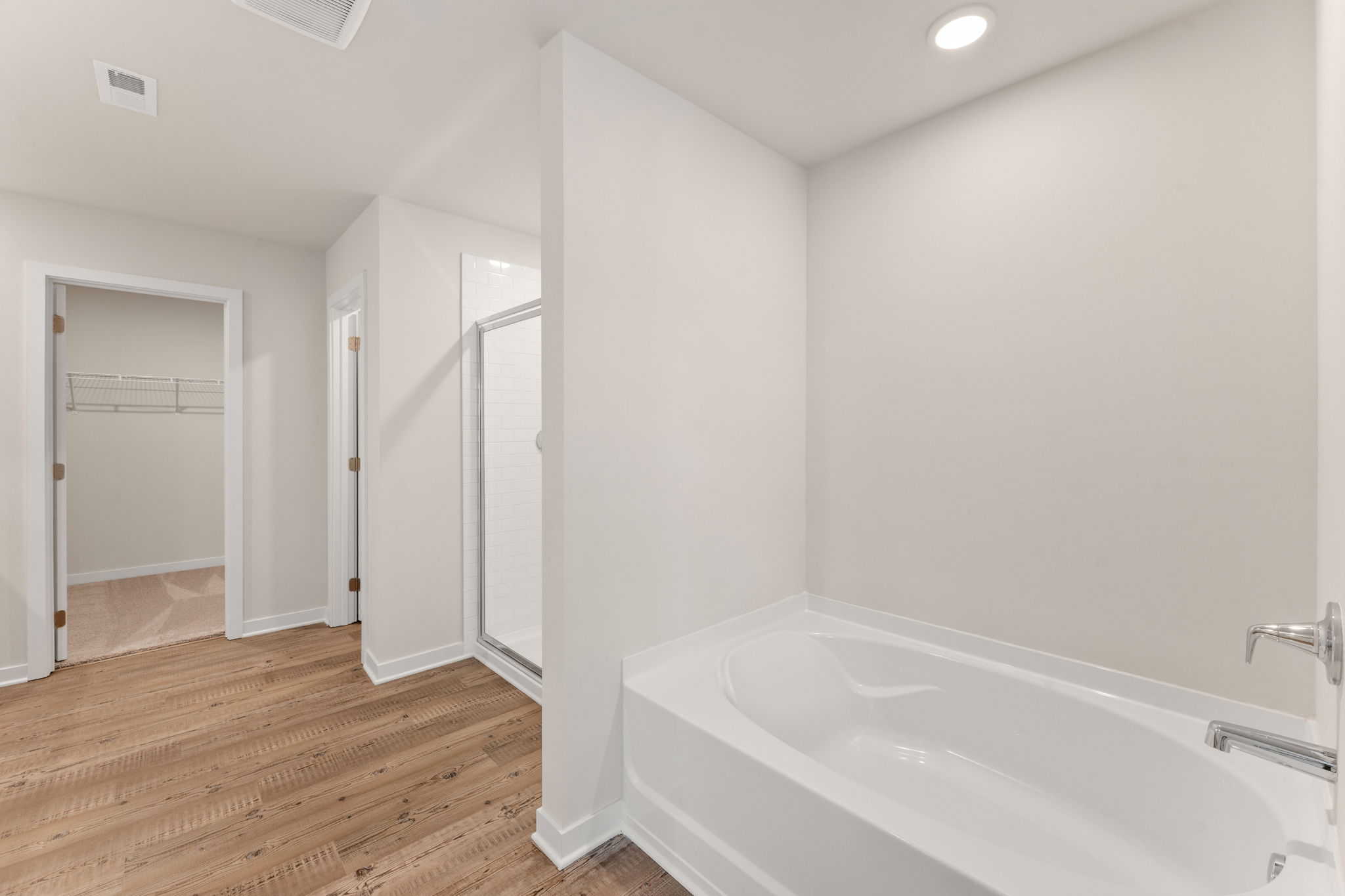 A bathroom with a tub and shower.