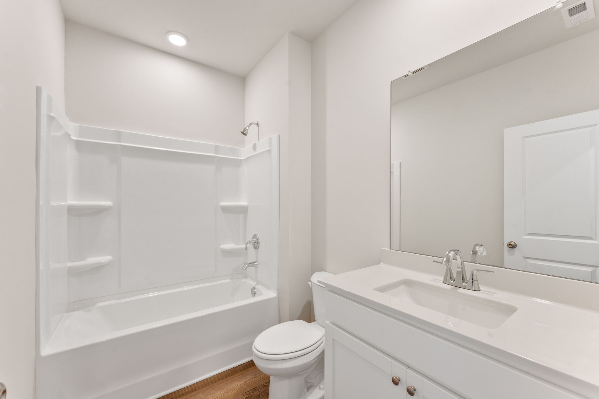 A bathroom with a tub sink and toilet.